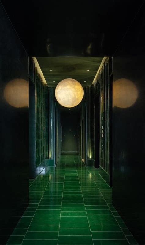 An Empty Hallway With Green Tiled Floors And Lights