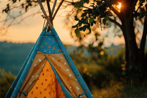 A Single Teepee Tent Sits On The Grassy Ground Ready For Camping Or