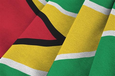 Premium Photo Guyana Flag With Big Folds Waving Close Up Under The