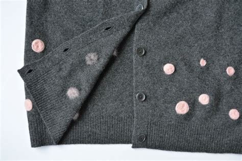 A Gray Sweater With Pink Polka Dots On It