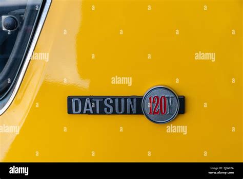 A Closeup Of A Car Emblem Details Of A Yellow Nissan Datsun Y Stock