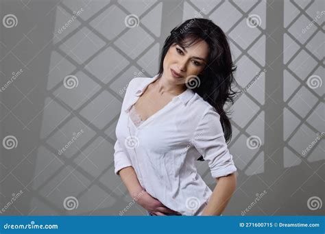 A Beautiful Brunette Woman In A Casual Outfit In The Studio Stock Image