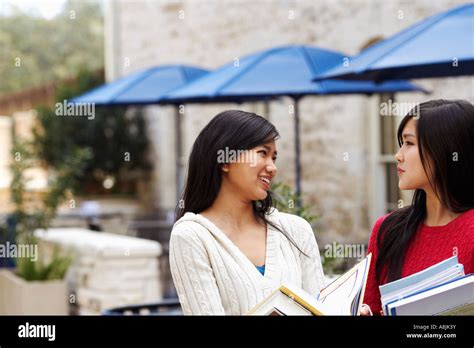 Two Young Women Talking To Each Other Stock Photo Alamy