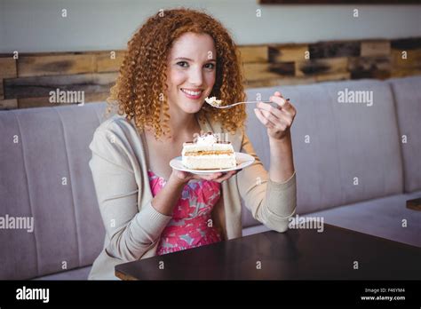 Portrait Of A Happy Pretty Brunette Eating A Cake Stock Photo Alamy