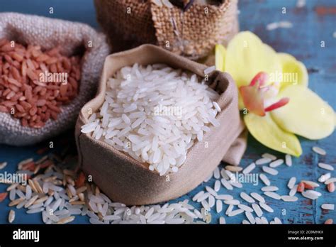 Different Types Of Rice In Sacks On Wooden Background Stock Photo Alamy