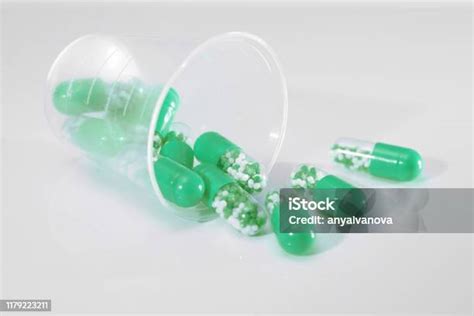 Green Capsules With Medication On White Background Stock Photo