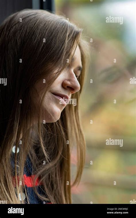 Sad Woman Looking Out Of The Window Stock Photo Alamy