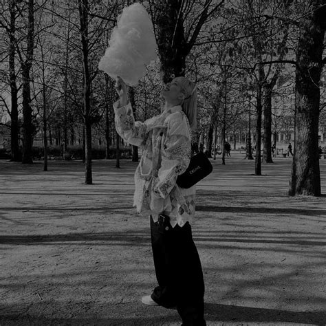 Black And White Photograph Of A Person Holding Something Up To Their