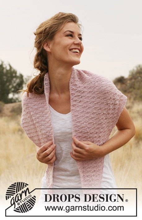 A Woman Wearing A Pink Knitted Shawl In Front Of A Field With Trees