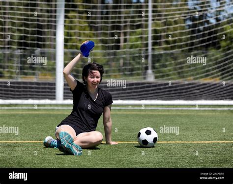 Teen Girl Pouring Water On Her Head During A Hot Day On The Soccer