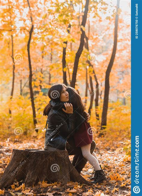 Mother And Daughter Spend Time Together In Autumn Yellow Park Season