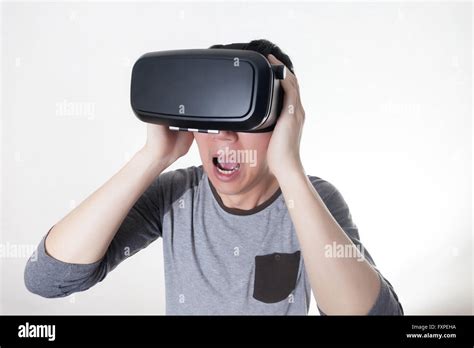 Asian Man Wearing Vr Goggle And Immersing Himself In Vr Multimedia In