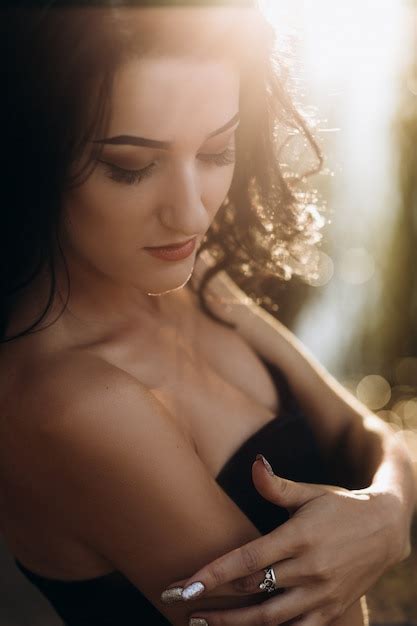 Free Photo Gorgeous Brunette Woman In Black Dress Holds Hands On Her