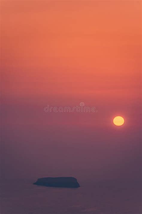 Idyllic Scene Of A Sunset With An Eye Catching Red Sun And An Island In