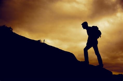 Premium Photo Man Climbing Up A Mountain