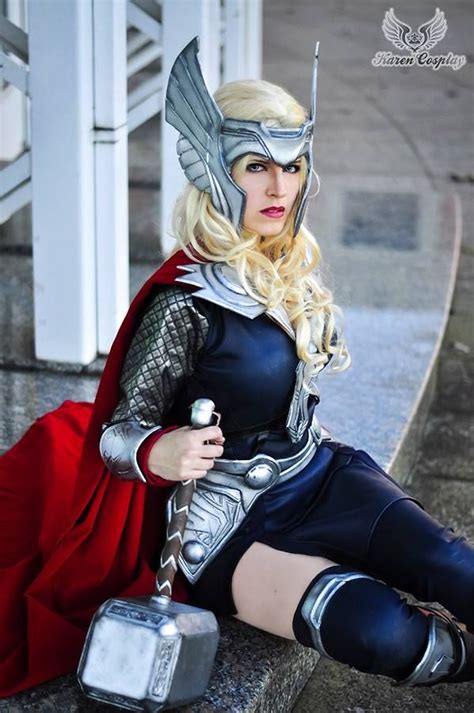 A Woman Dressed As Thor From The Avengers Movie Sitting On Steps With