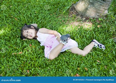 Little Asian Girl Lying On Green Grass Stock Photo Image Of Meadow