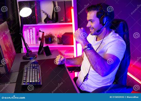 Winner Streamer Playing Online Game Wearing Headphones Raising Fist Up