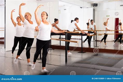 Group Of Women Perform The Battement Tendu Movement Standing In A