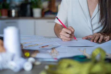 Faceless Woman Draws Sketches Of Swimwear With A Pencil Close Up Of