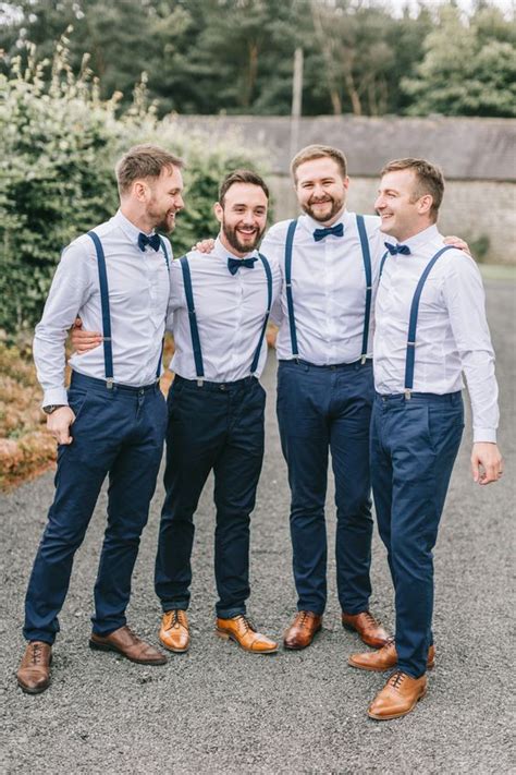 A Stylish Groom S Outfit With Navy Pants And Suspenders Light Blue