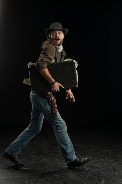 Premium Photo Portrait Of Man Holding Hat Against Black Background