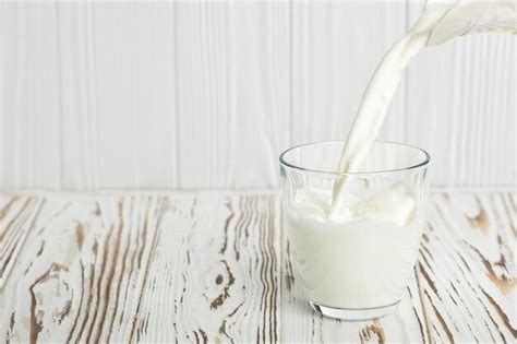 Premium Photo Milk Pouring Into Glass