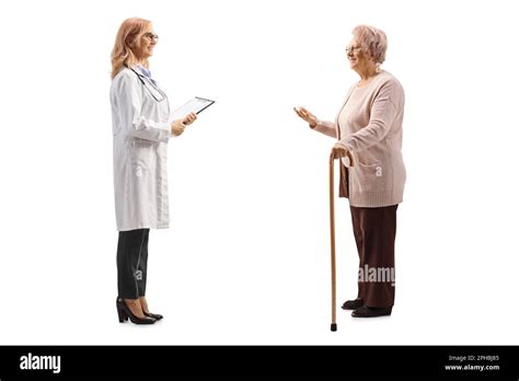 Full Length Profile Shot Of An Elderly Woman Talking To A Female