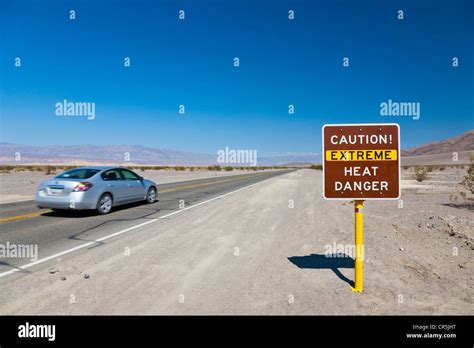 Caution Extreme Heat Danger Sign With Car Passing Route 190 Death