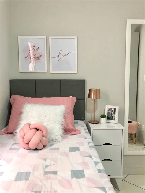 A Bed With Pink And Grey Sheets In A Bedroom Next To Two Pictures On