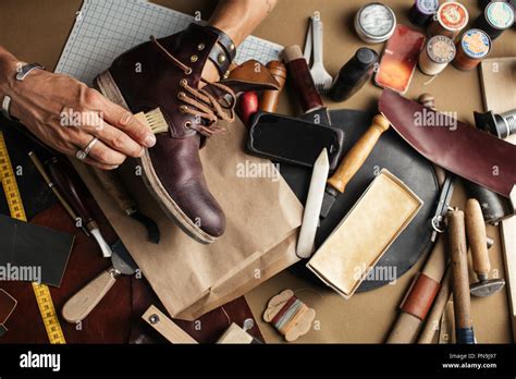 Close Up Of Shoe Maker Hands Producing Boots In His Leather Workshop