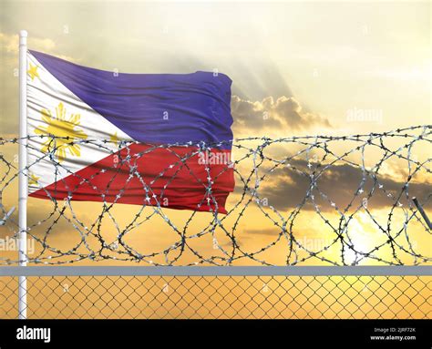 Flagpole With The Flag Of Philippines Against The Sky And Behind A