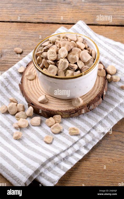 Cicerchia Or Indian Pea On A Ceramic Bowl With Napkin On Natural Wooden