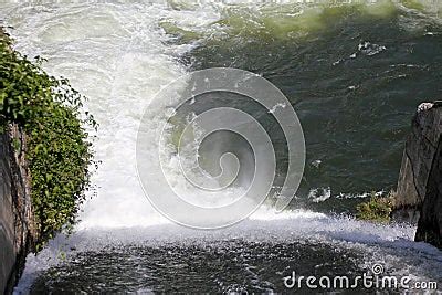 Dam Wall And Overflow Of Iskar Dam. Water Flowing Over A Dam Wall. Mist Rising Above The Iskar ...