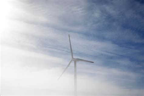 Premium Photo Wind Turbine Generating Electricity In Foggy Day