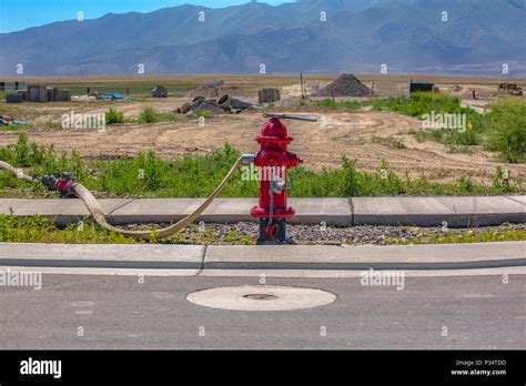 Red Fire Hydrant With Hose Connected For Use In Construction Zone In