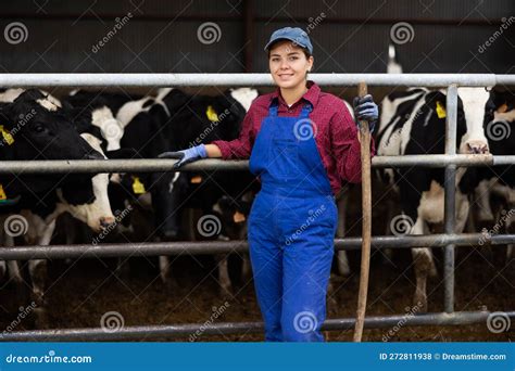 Portrait Of Smiling European Female Farmer In Uniform With Rake During