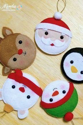 Four Christmas Ornaments On A Wooden Table With One Wearing A Santa