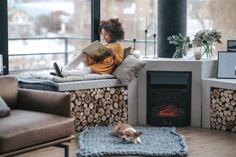 Premium Photo | Leisure. a girl reading a book on the window