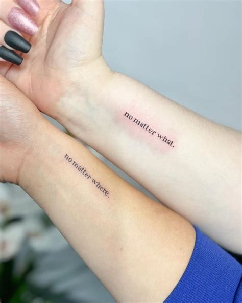 Two Women With Matching Tattoos On Their Arms Holding Each Other S