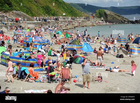 Looe beach, Cornwall, UK. Tourists enjoy the weather at Looe beach in ...