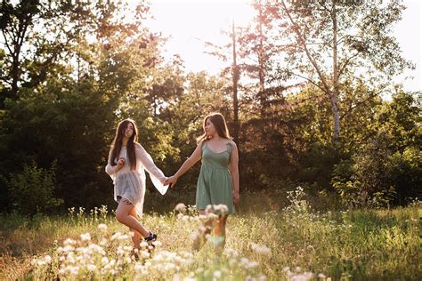 Lesbian Couple Holding Hands While Walking In Forest In Summer Photograph By Cavan Images Pixels