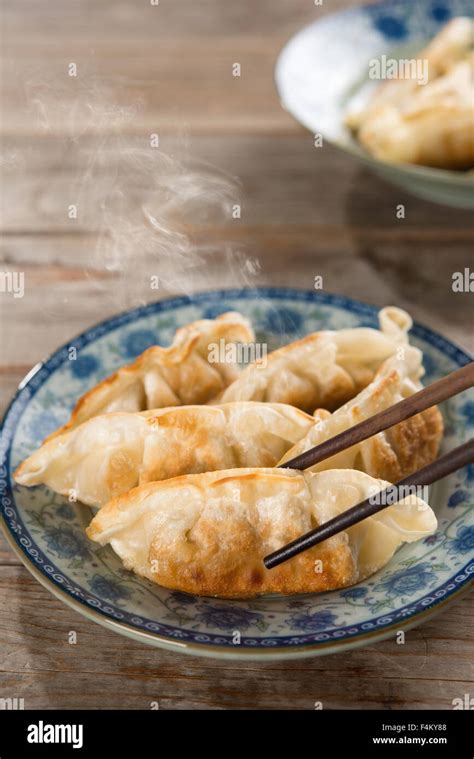 Fresh Pan Fried Dumpling On Plate With Chopsticks Chinese Food With