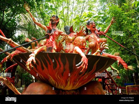 Sculpture of sinners boiling in a pot in Buddhist Garden of Hell, Wat ...