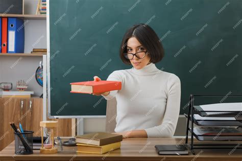 Premium Photo Confident Young Female Teacher Wearing Glasses Holding