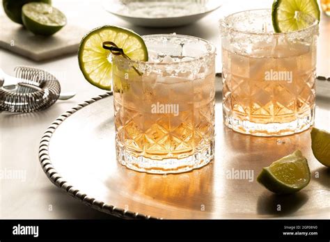 Margarita Cocktails With Salted Rims On A Metal Tray With Ingredients