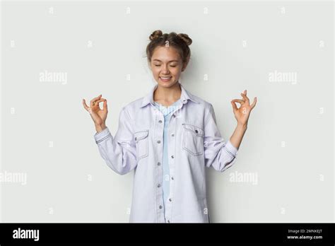Calm Brunette Woman With Closed Eyes And Smiling Peacefully Meditating