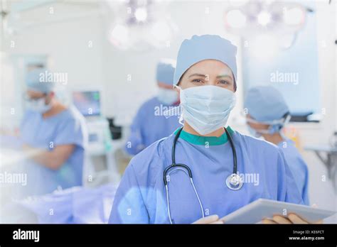 Portrait Confident Female Surgeon Wearing Surgical Mask Using Digital