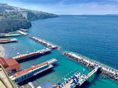 an aerial view of a harbor with boats and buildings on the water ...