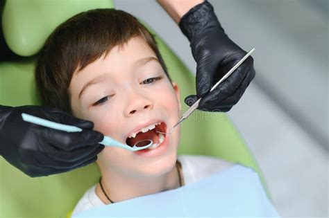 Dentist Examining Little Boy S Teeth In Clinic Stock Photo Image Of